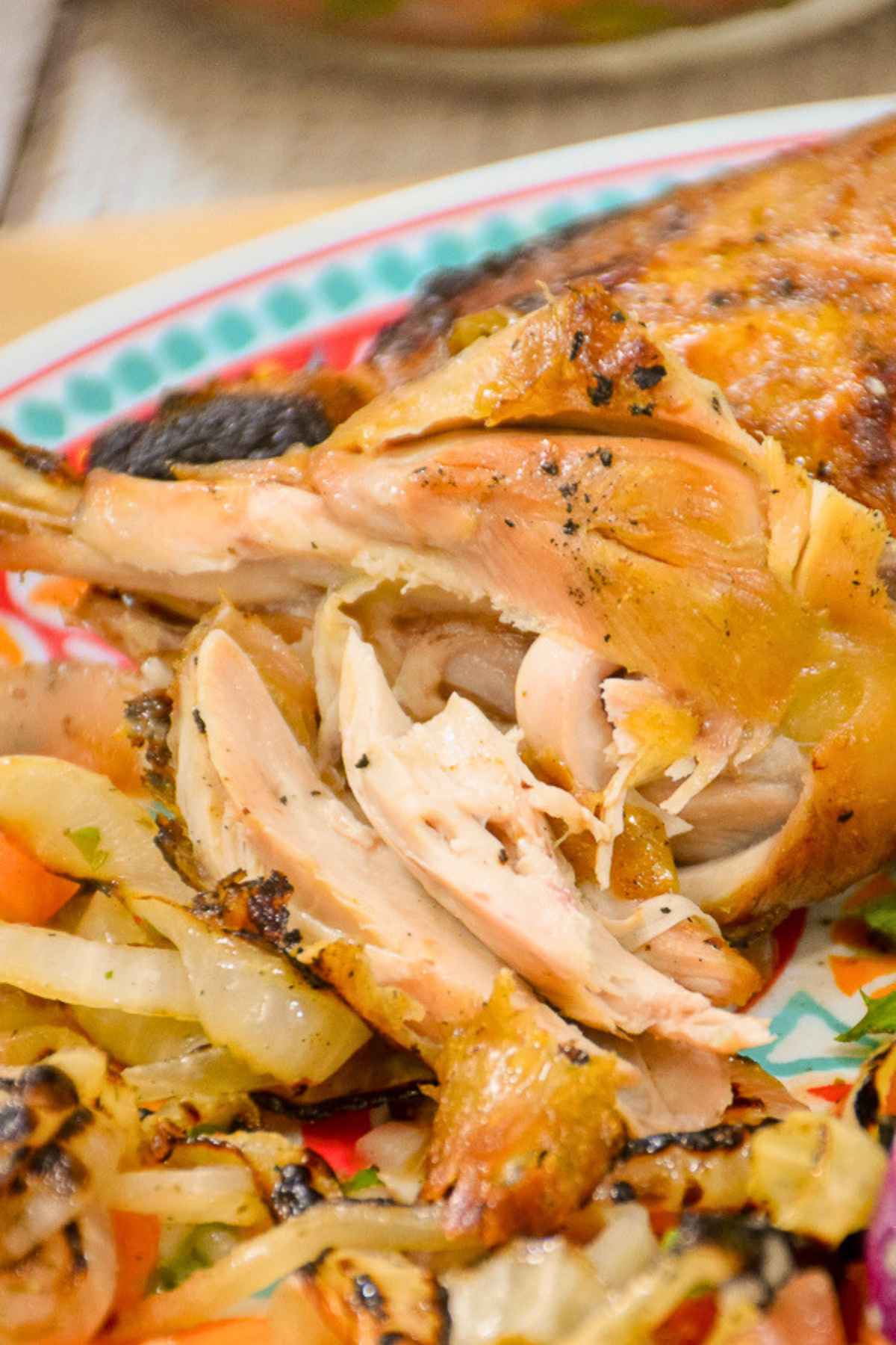 Close up of fireman's bbq grilled chicken with tender meat and grilled onions on a plate.