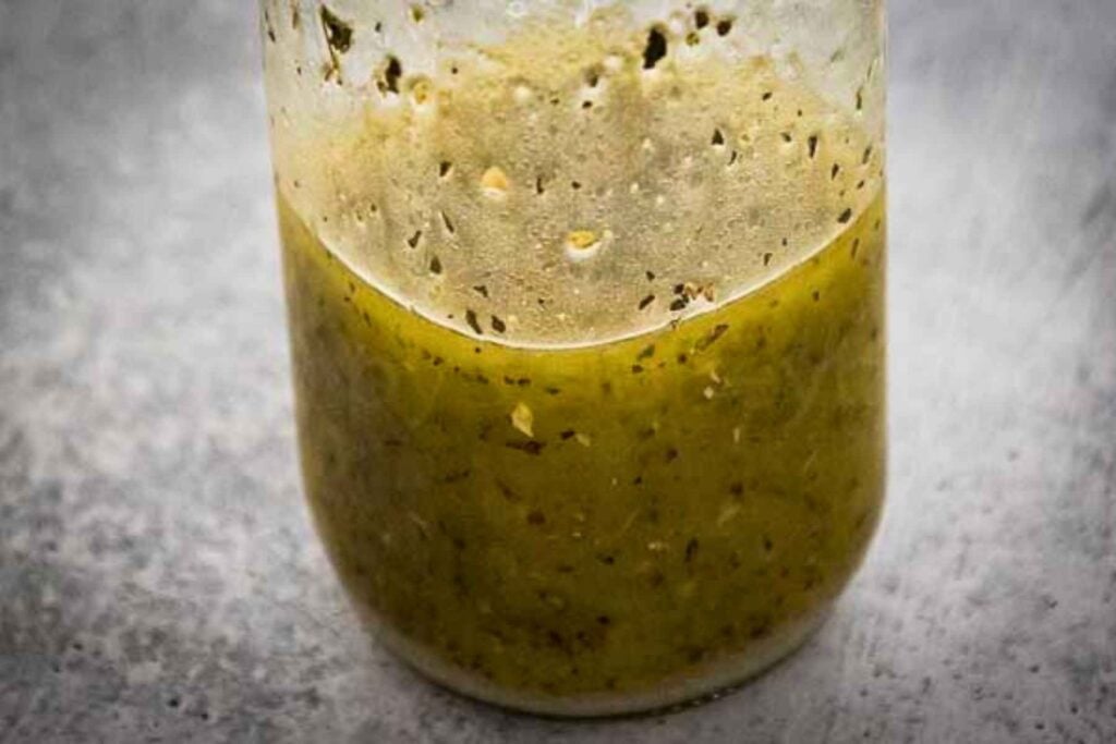Clear glass jar filled with homemade Italian Vinaigrette dressing.