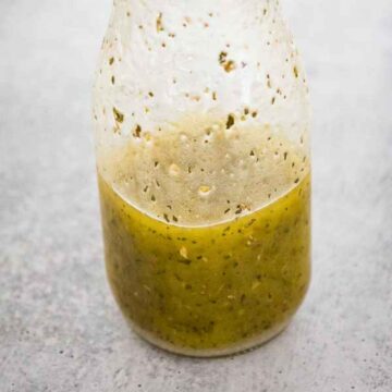 Clear glass jar filled with homemade Italian Vinaigrette dressing.