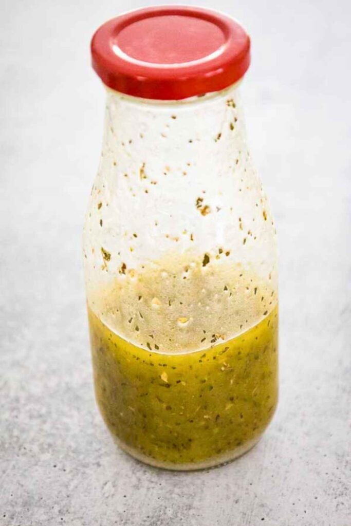 Clear glass jar filled with homemade Italian Vinaigrette dressing.