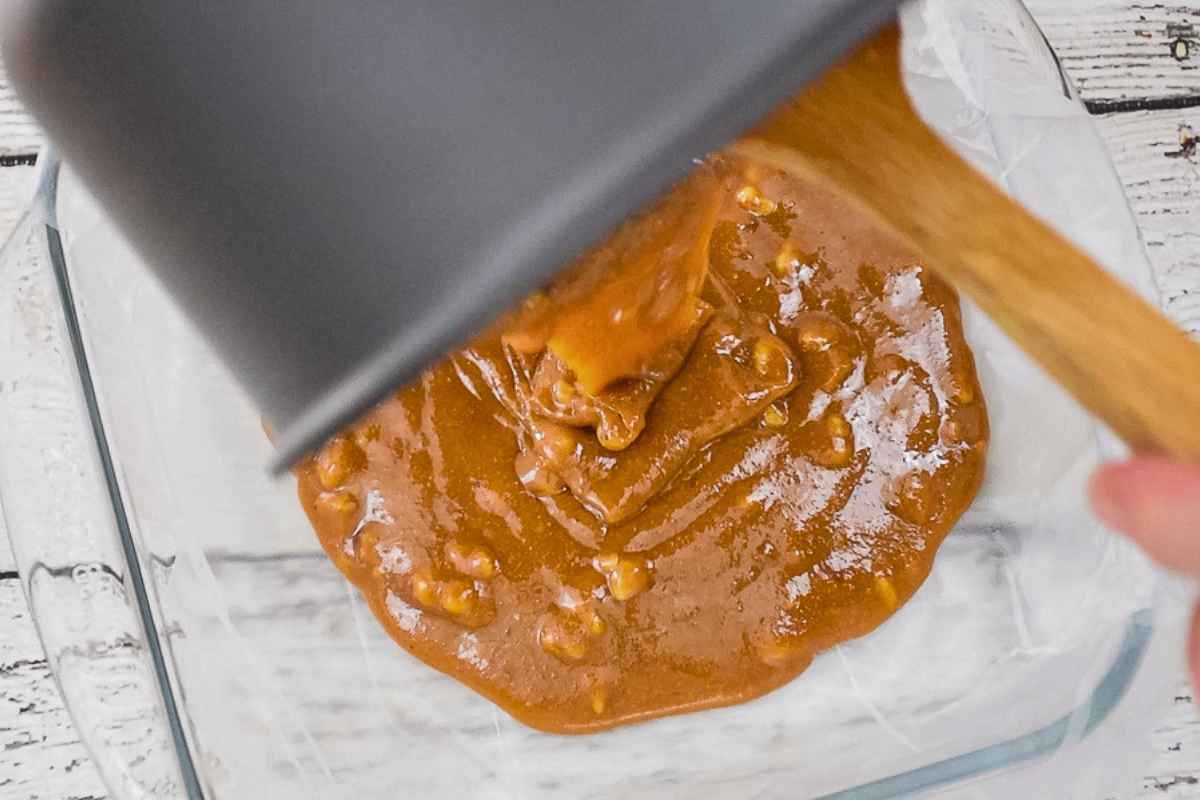 Pouring the fudge into a prepared dish.