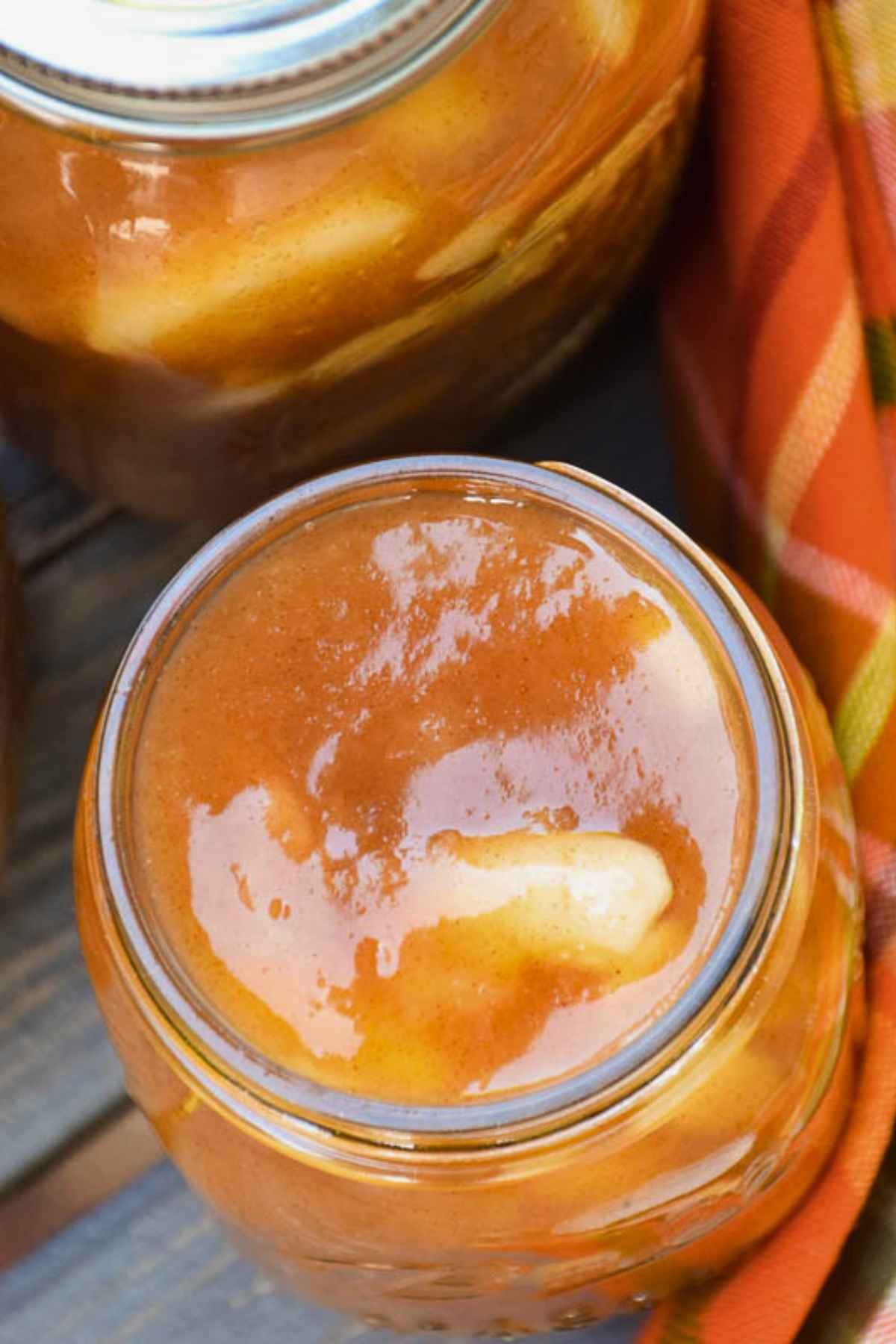 Overhead image of a glass jar filled with homemade apple pie filling.