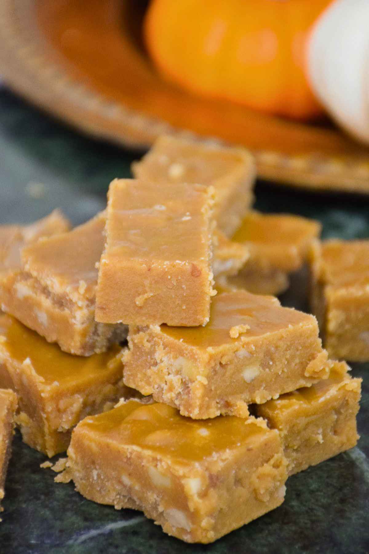 A stack of brown sugar fudge on a marble board.