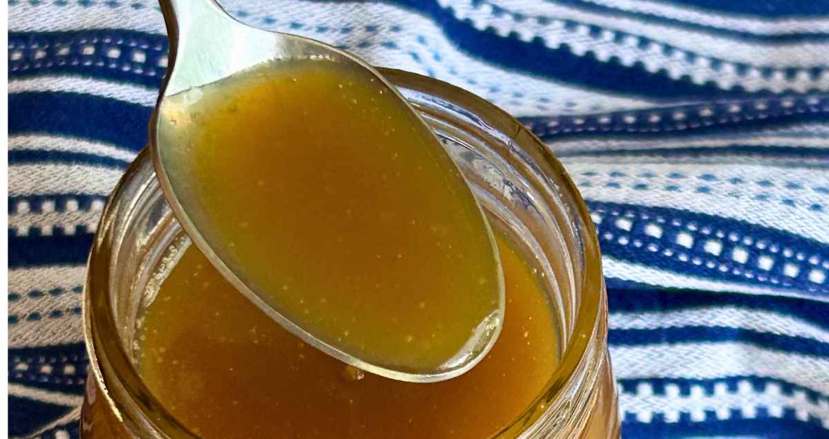 Nanny's Homemade Butterscotch Sauce on a spoon.