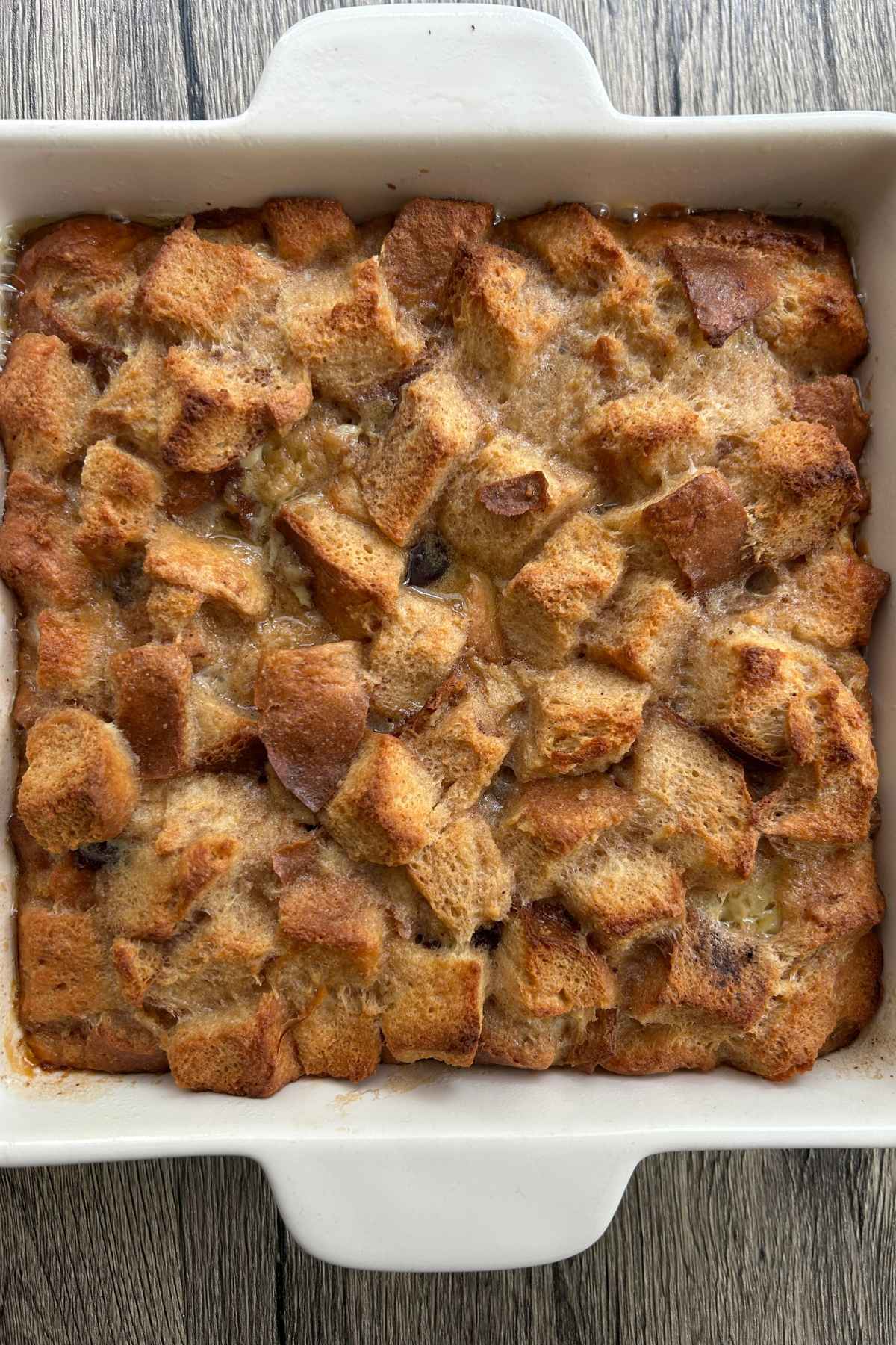 Overhead image of baked, golden-brown dessert in a white baking dish.