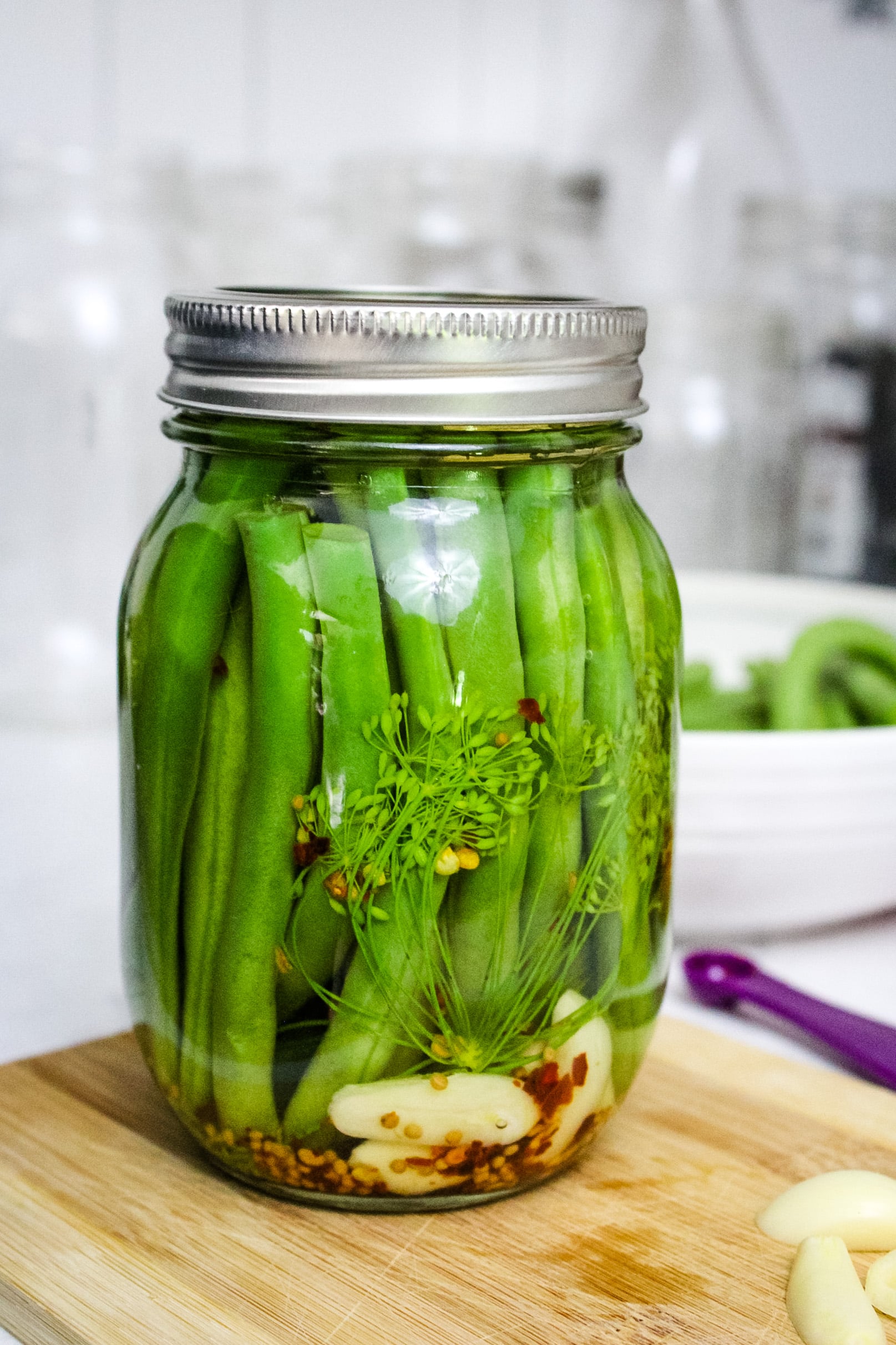 A freshly canned dilly beans in a glass jar.
