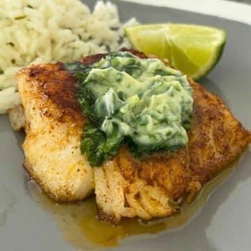 Upclose image of Skillet Cod topped with Cilantro Lime Butter Sauce.