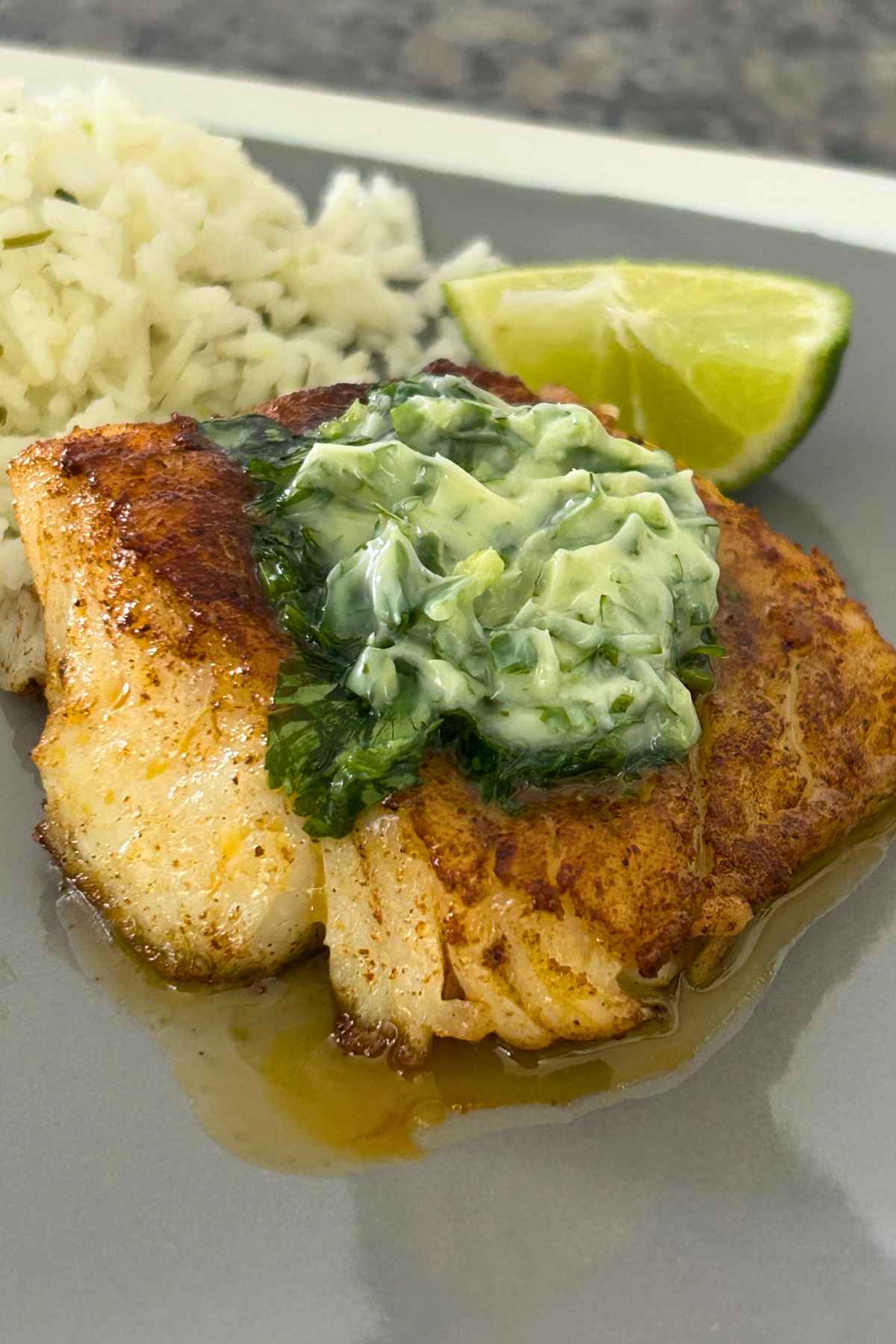 Upclose image of Skillet Cod topped with Cilantro Lime Butter Sauce.