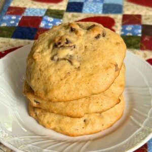 A stack of 3 date nut cookies on a white plate.