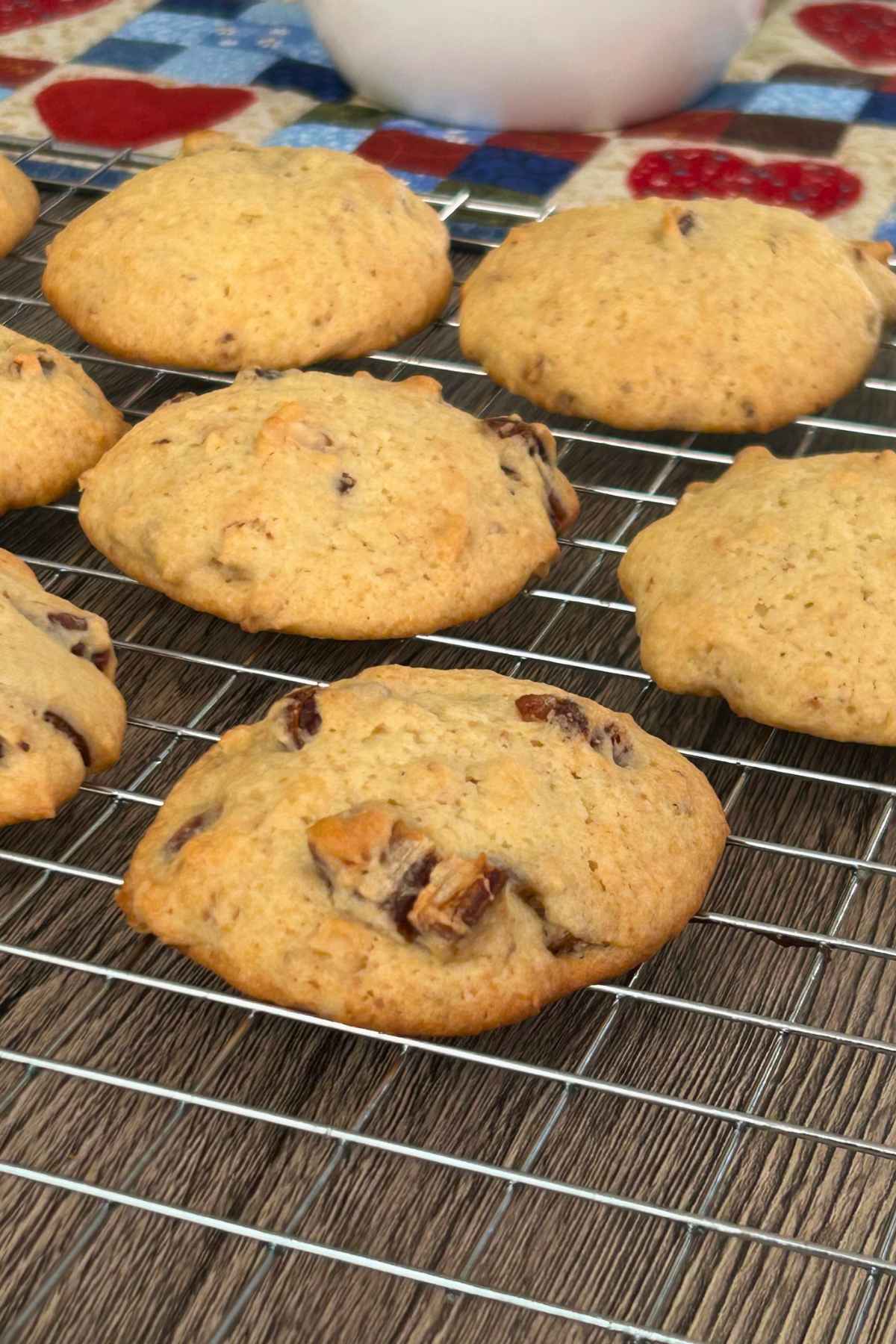 Several date nut cookies on a wire cooling rack.